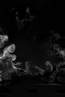 extinguido carbones en parrilla parilla en negro antecedentes con blanco fumar foto