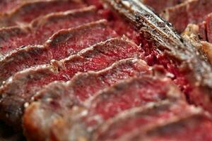 Sliced Steak T-bone lying on wooden board. Close-up photo