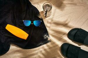 Top view of summer accessories on sandy beach photo