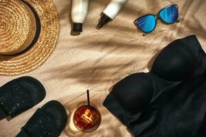 Summer background with straw hat, sunglasses, sunscreen bottle and flip flops photo