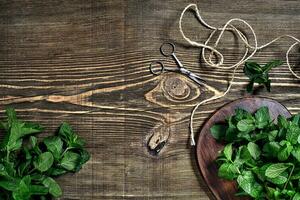 Fresh mint leaves on wooden background. Top view. Copy space photo