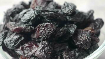 black raisin on white background, close up, video