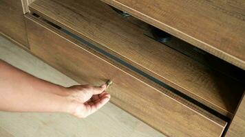 man's hand open drawer wooden in cabinet video