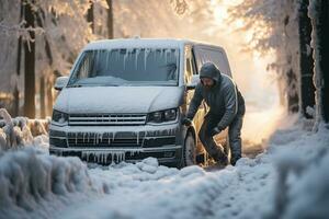 Shovel in hand a vanlifer battling winters touch on frosted vehicle photo