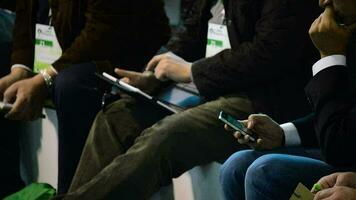 People writing a message in mobile telephone and tablet video