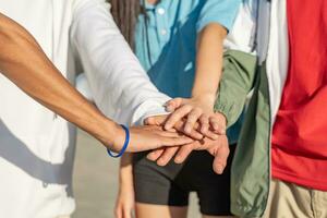 College student teamwork stacking diverse hand togetherness concept. photo