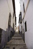 a narrow street with steps leading up to a building photo
