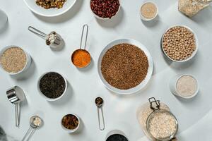 Flat lay composition with different types of cereals on white background photo