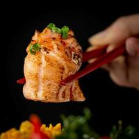 Japanese cuisine. Roasted chicken on a black background with chopsticks photo