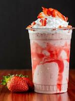 Strawberry milkshake with whipped cream and fresh strawberries. photo