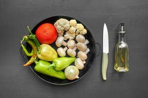 Top view on a fresh vegetables for healthy nutrition. Black background with copyspace. photo