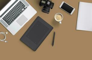 Minimal work space Laptop, camera, coffee, camera, pen, pencil, notebook, smartphone, stationery on brown background for copy space. photo