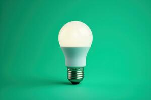 Efficient LED lightbulb glowing isolated on a gradient blue background photo