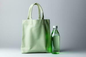 Reusable glass water bottle and fabric tote bag isolated on a gradient background photo