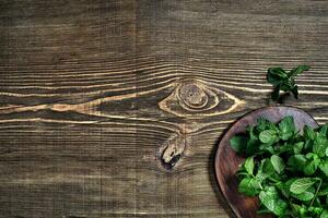 Fresh mint leaves on wooden background. Top view. Copy space photo