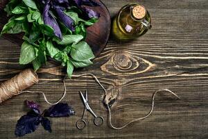 Green and purple fresh basil on wooden background. Top view photo