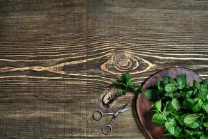 Fresh mint leaves on wooden background. Top view. Copy space photo