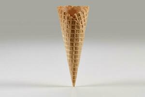 Empty, crispy wafer cone for ice cream isolated on white. Concept of food, treats. Mockup, template for your advertising and design. Close up photo