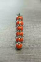 Cherry tomatoes on a gray wooden table. Selective focus. photo