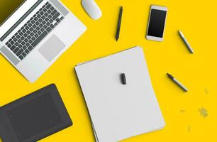 Minimal work space concept smart phone, pen, pencils, notepad, notebook, tablet, laptop, composition on yellow background. Flat lay, top view photo