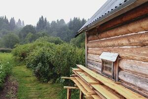 Front view of wooden house in russian village in sunny summer day photo