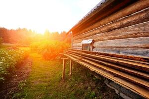 Front view of wooden house in russian village in sunny summer day photo
