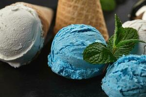 Close-up shot of a creamy and blueberry ice cream served on a dark slate, black background. photo