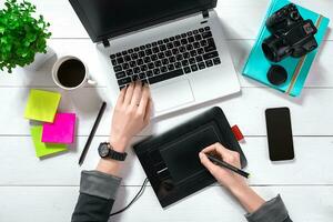 Overhead view of businesswoman working at computer in office photo