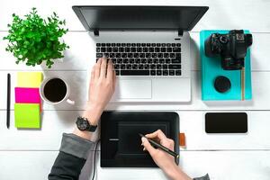 Overhead view of businesswoman working at computer in office photo