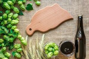 Bottle and Glass beer with Brewing ingredients. Hop flower with wheat. Top view. photo