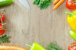 Vegetables on a wooden background. Top view with copy space photo