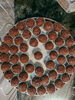 Chocolate truffles on a baking sheet in a bakery. photo