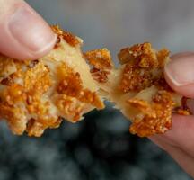 Crispy croutons in hand, close-up. photo