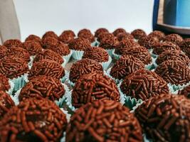 Chocolate truffles on display for sale at a market. photo
