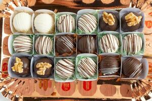 Assortment of chocolates in a box close-up. photo