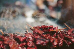 Barbecued meat on the grill. Shallow depth of field photo