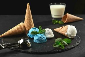 Close-up shot of a creamy and blueberry ice cream served on a dark slate, black background. photo