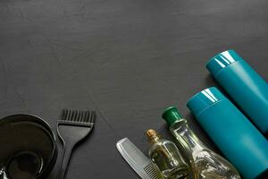 Top view of a professional hairdresser kit with copy space on a black background. photo