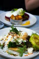 Sandwiches with poached eggs and avocado on a white plate photo