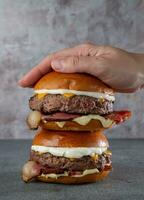 Big hamburger with beef, cheese, onion, tomato and mayonnaise photo