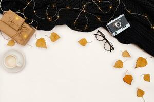 Autumn accessories for woman with yellow leaves and coffee with milk, top view photo