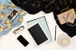 Romantic autumn mock up. Sheet of blue paper, tablet, smart, pencils, cup of cappuccino and old camera. Top view. Flat lay. photo