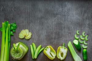 Green vegetable smoothie with celery, ginger and cucumber photo