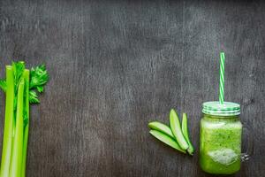 Green vegetable smoothie with celery and cucumber photo