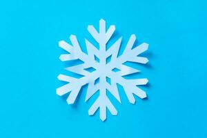 snowflake paper cut on blue background photo