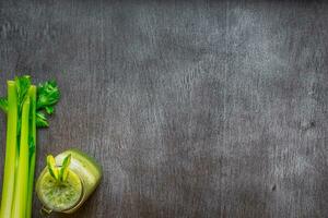 Green vegetable smoothie with celery and cucumber photo