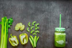 Green vegetable smoothie with celery, ginger and cucumber photo