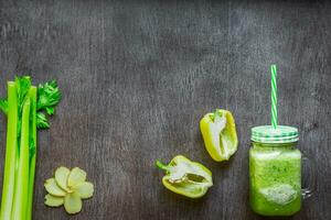 Green vegetable smoothie with celery, ginger and cucumber photo