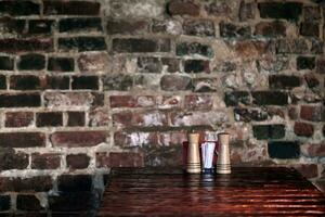 Empty wooden deck table with vintage brick wall pattern. photo