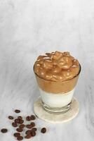 Dalgona coffee, Iced fluffy creamy whipped trend drink with coffee foam and milk photo